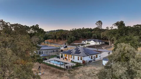 an aerial view of a house with a yard