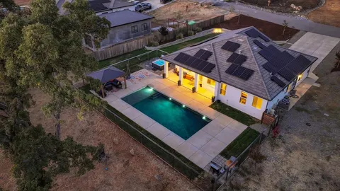 an aerial view of house with swimming pool