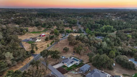 a view of a city with lush green forest