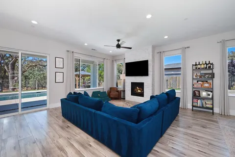 a living room with fireplace furniture and a flat screen tv