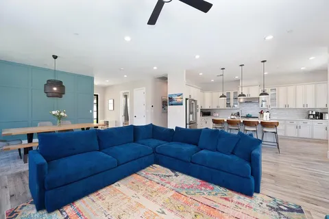 a living room with furniture and kitchen view