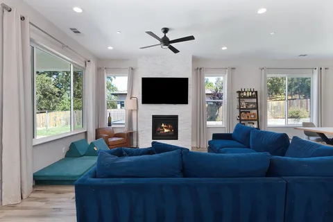 a living room with furniture a fireplace and a flat screen tv