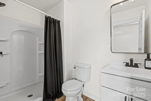 a bathroom with a toilet a sink and shower
