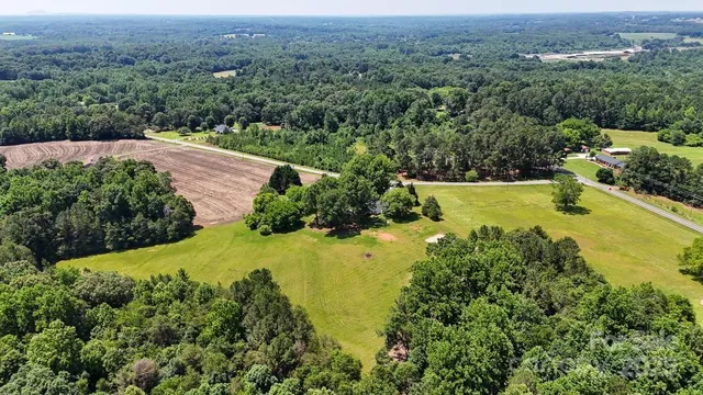 an aerial view of a houses with a yard