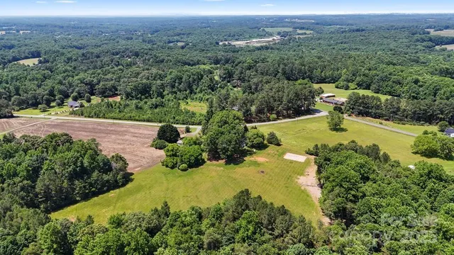 an aerial view of huge green field with lots of green space