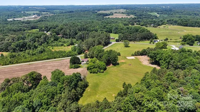 an aerial view of a houses with yard
