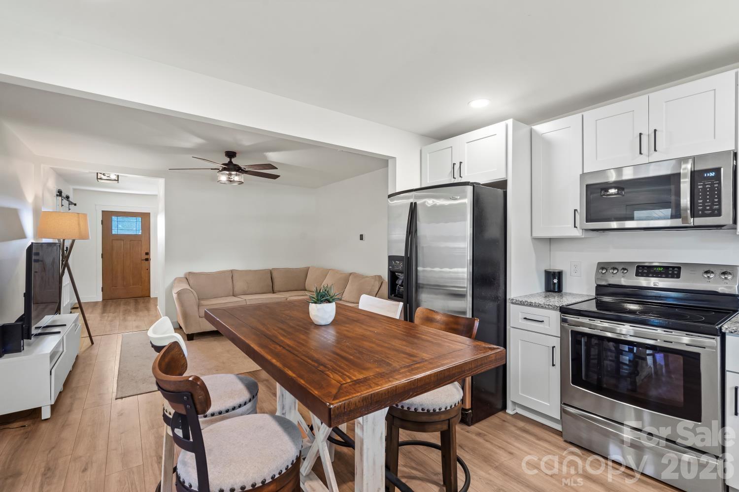 5740 Crouse Road Crouse, NC 28033 - Photo 6 of 28 a kitchen with stainless steel appliances granite countertop a stove a refrigerator a microwave a sink a stove and island