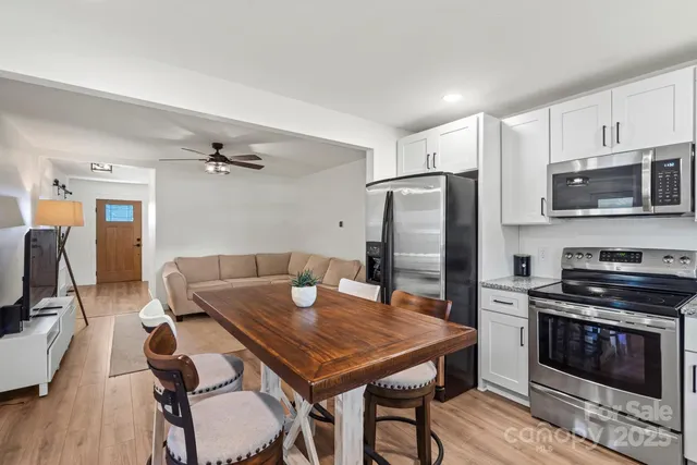 a kitchen with stainless steel appliances granite countertop a stove a refrigerator a microwave a sink a stove and island