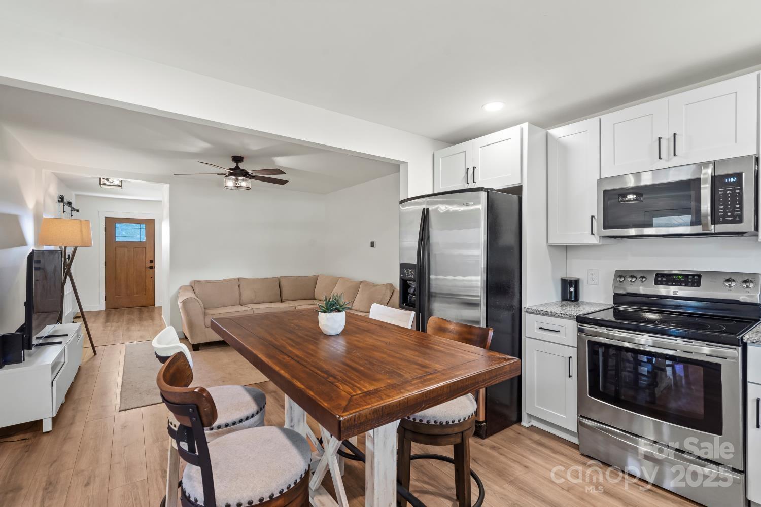 5740 Crouse Road Crouse, NC 28033 - Photo 7 of 28 a kitchen with stainless steel appliances granite countertop a stove a refrigerator a microwave a sink a stove and island