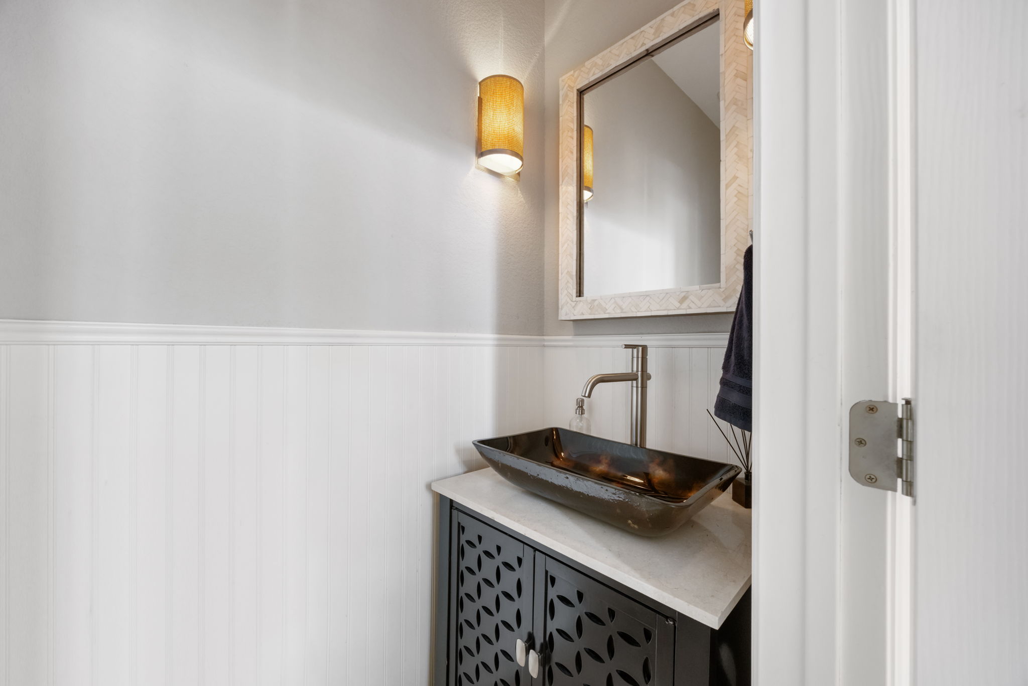 1910 Rue De St Tropez, Unit 6 Austin, TX 78746 - Photo 16 of 37 A stylish half bath with a unique vessel sink and intricate vanity.