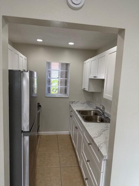 650 Southwest 2nd Avenue, Unit 253 Boca Raton, FL 33432 - Photo 11 of 32 a kitchen with stainless steel appliances granite countertop a refrigerator a stove a sink and a microwave