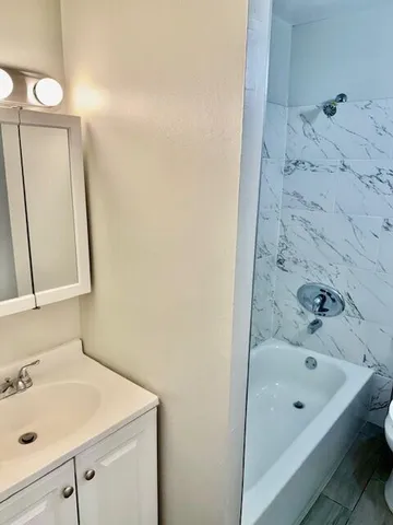 a bathroom with a tub and sink