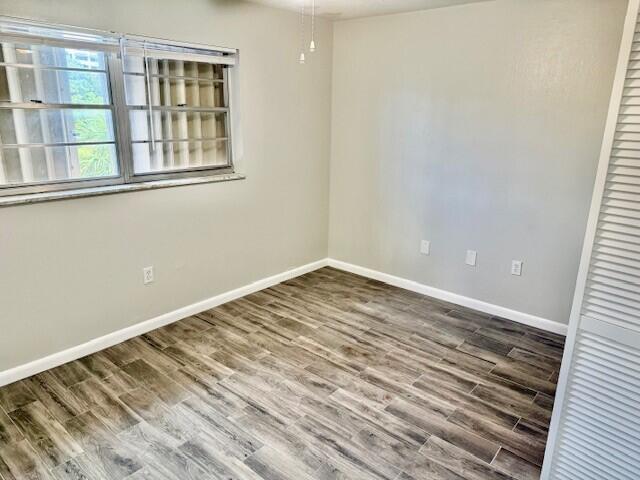 650 Southwest 2nd Avenue, Unit 253 Boca Raton, FL 33432 - Photo 25 of 32 a view of a room with wooden floor and windows