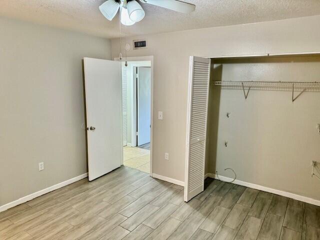 650 Southwest 2nd Avenue, Unit 253 Boca Raton, FL 33432 - Photo 26 of 32 a view of an empty room with wooden floor and a ceiling fan
