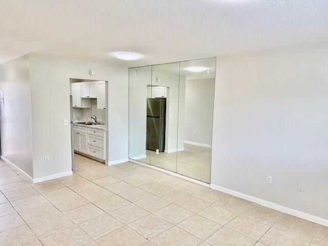 650 Southwest 2nd Avenue, Unit 253 Boca Raton, FL 33432 - Photo 5 of 32 an empty room with cabinet and mirrors