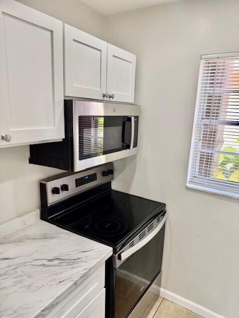 650 Southwest 2nd Avenue, Unit 253 Boca Raton, FL 33432 - Photo 7 of 32 a kitchen with stainless steel appliances granite countertop a stove microwave and sink