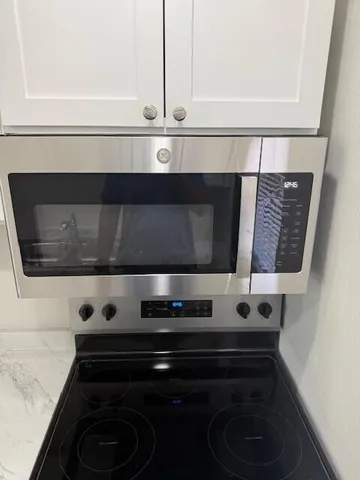 a kitchen with stainless steel appliances granite countertop a refrigerator sink and cabinets