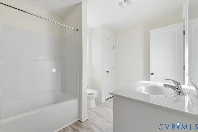 a bathroom with a sink a toilet and a bathtub