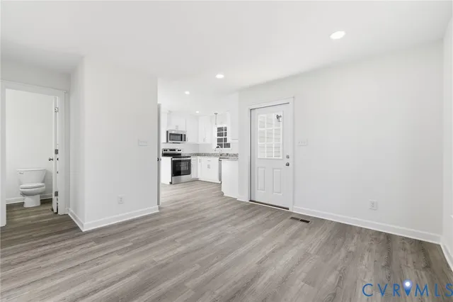 a view of a kitchen with wooden floor and a sink