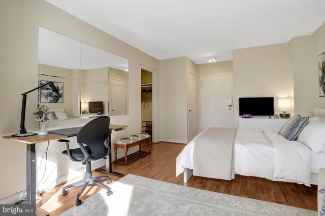 a bedroom with a bed window and a chair