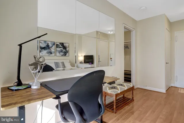 a living room with furniture a flat screen tv and a table