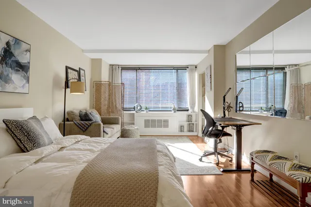 a large bedroom with a bed and large windows