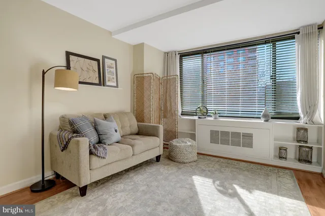 a living room with furniture and a large window