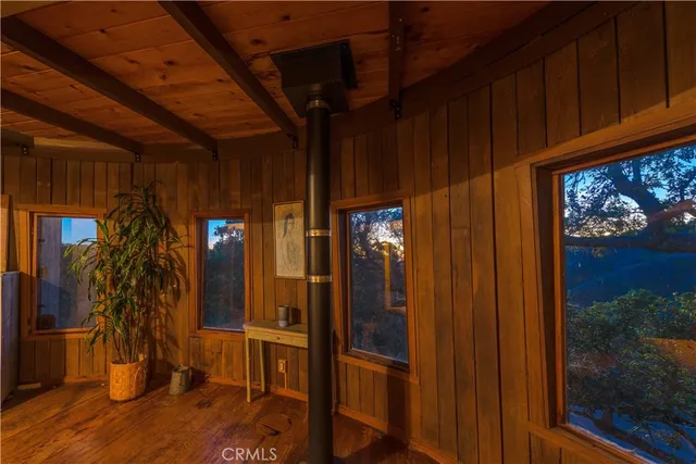 a view of a hallway with wooden floor and entryway