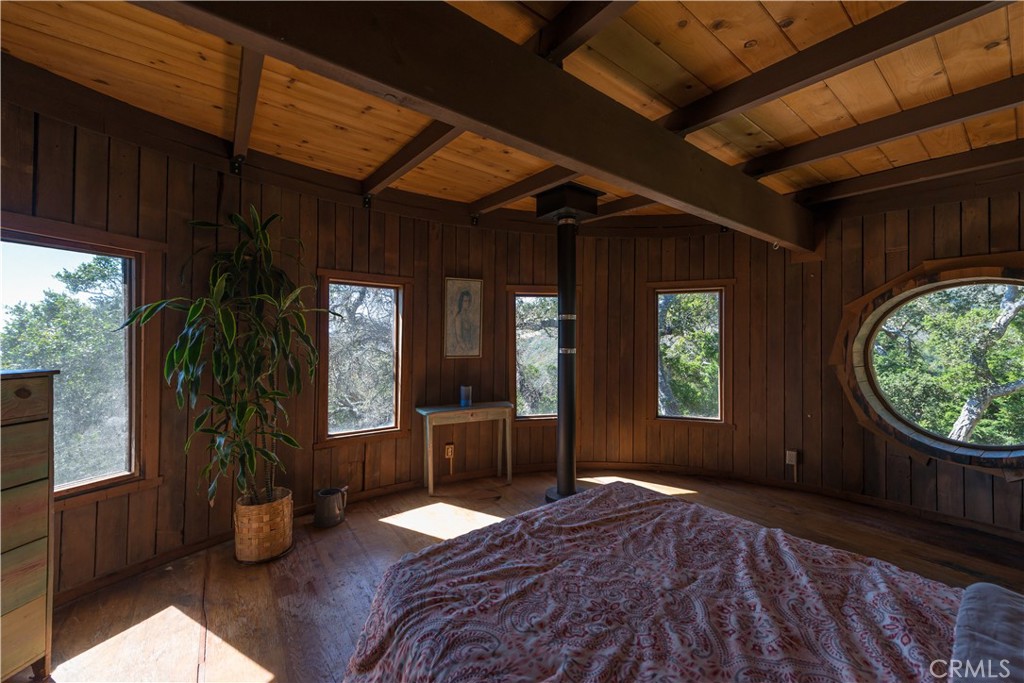 0 Pias Ranch Road Big Sur, CA 93920 - Photo 22 of 34 a bedroom with bed and a large window
