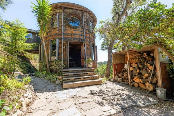 a front view of a house with plants