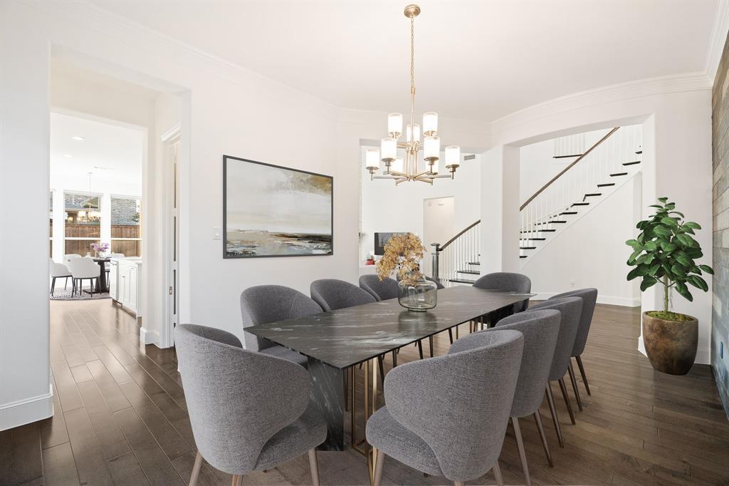 2441 Flat Creek Road Frisco, TX 75036 - Photo 13 of 34 a dining room with furniture potted plants and wooden floor