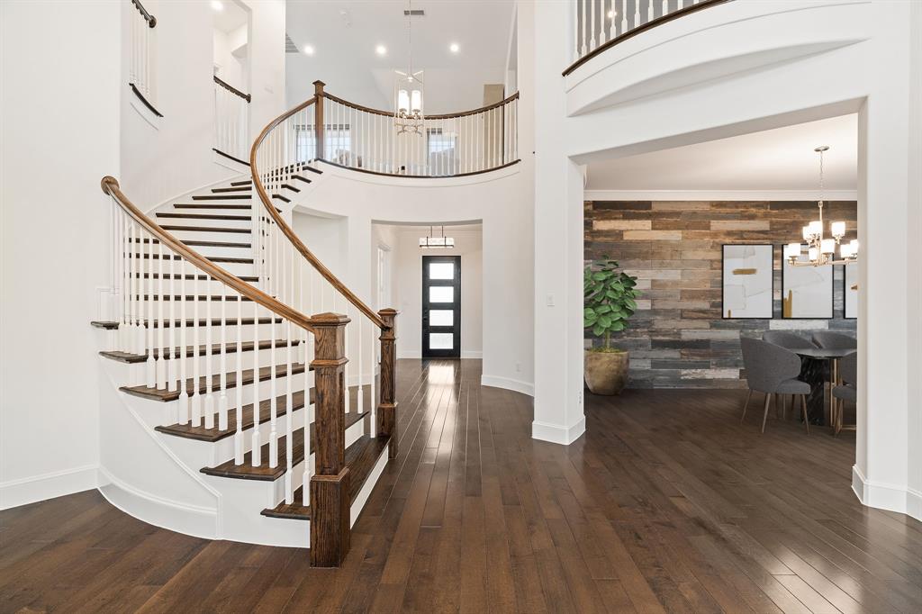 2441 Flat Creek Road Frisco, TX 75036 - Photo 14 of 34 a view of entryway with wooden floor and stairs