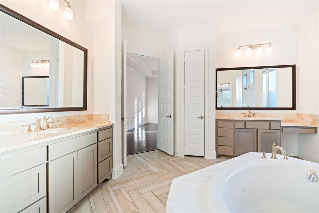 2441 Flat Creek Road Frisco, TX 75036 - Photo 18 of 34 a en suite bathroom with a double vanity sink and a mirror