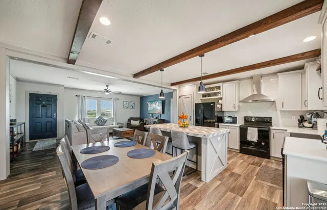a large kitchen with lots of counter space and stainless steel appliances