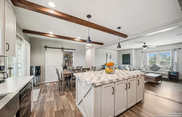 a view of a dining hall with furniture and wooden floor