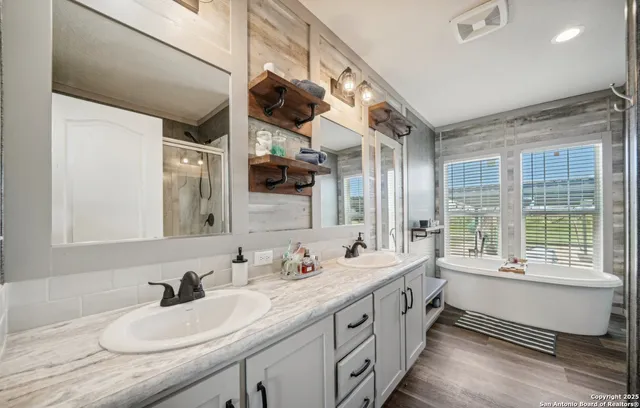 a bathroom with a double vanity sink and a large mirror