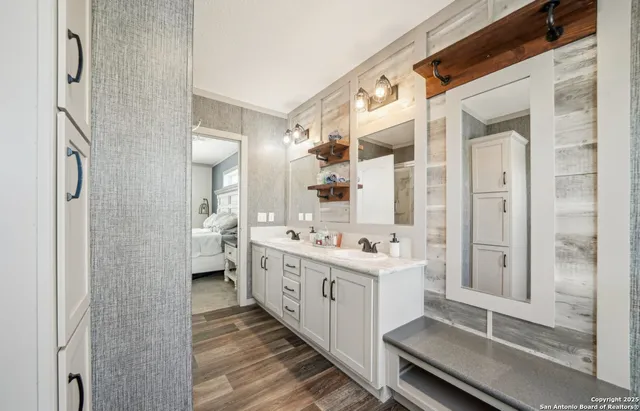 a bathroom with a double vanity sink toilet and shower