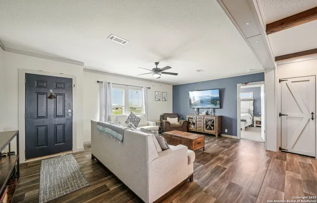 a living room with furniture and a large window