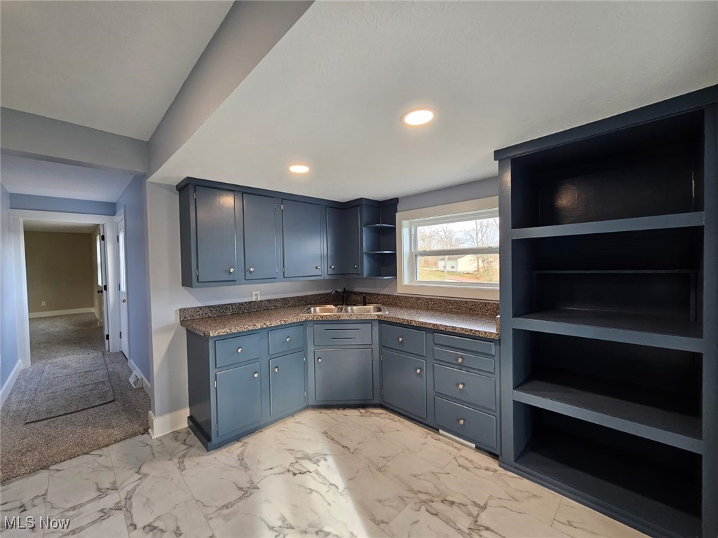 5961 State Rte 213 Toronto, OH 43964 - Photo 10 of 15 Kitchen featuring blue cabinets, sink, and light carpet