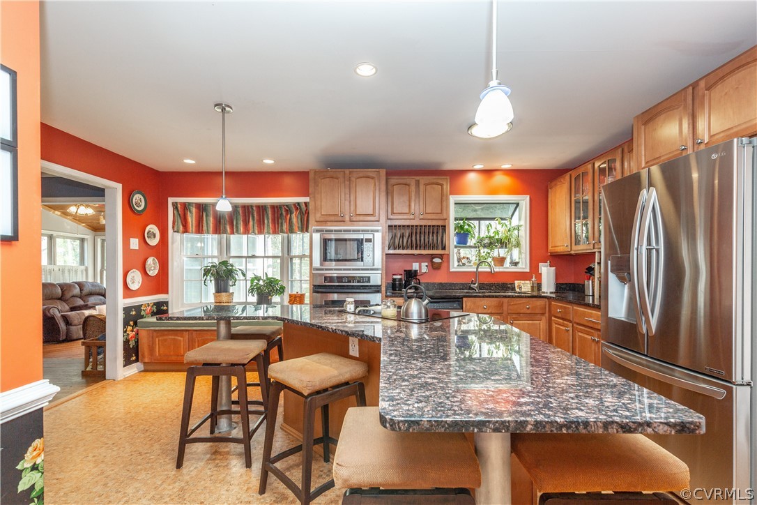 4530 Little Ridge Lane Chesterfield, VA 23832 - Photo 8 of 37 a kitchen with stainless steel appliances granite countertop table chairs and a chandelier