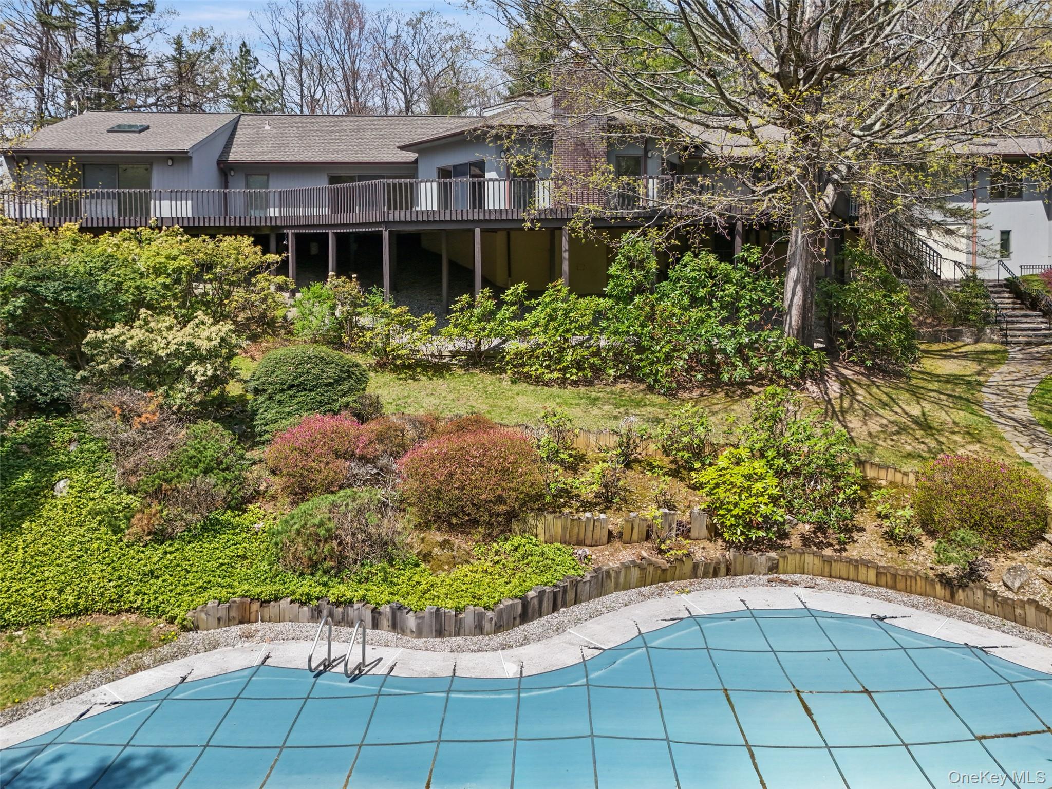 68 Old Aspetong Road Katonah, NY 10536 - Photo 4 of 13 a view of a house with a small yard and large trees