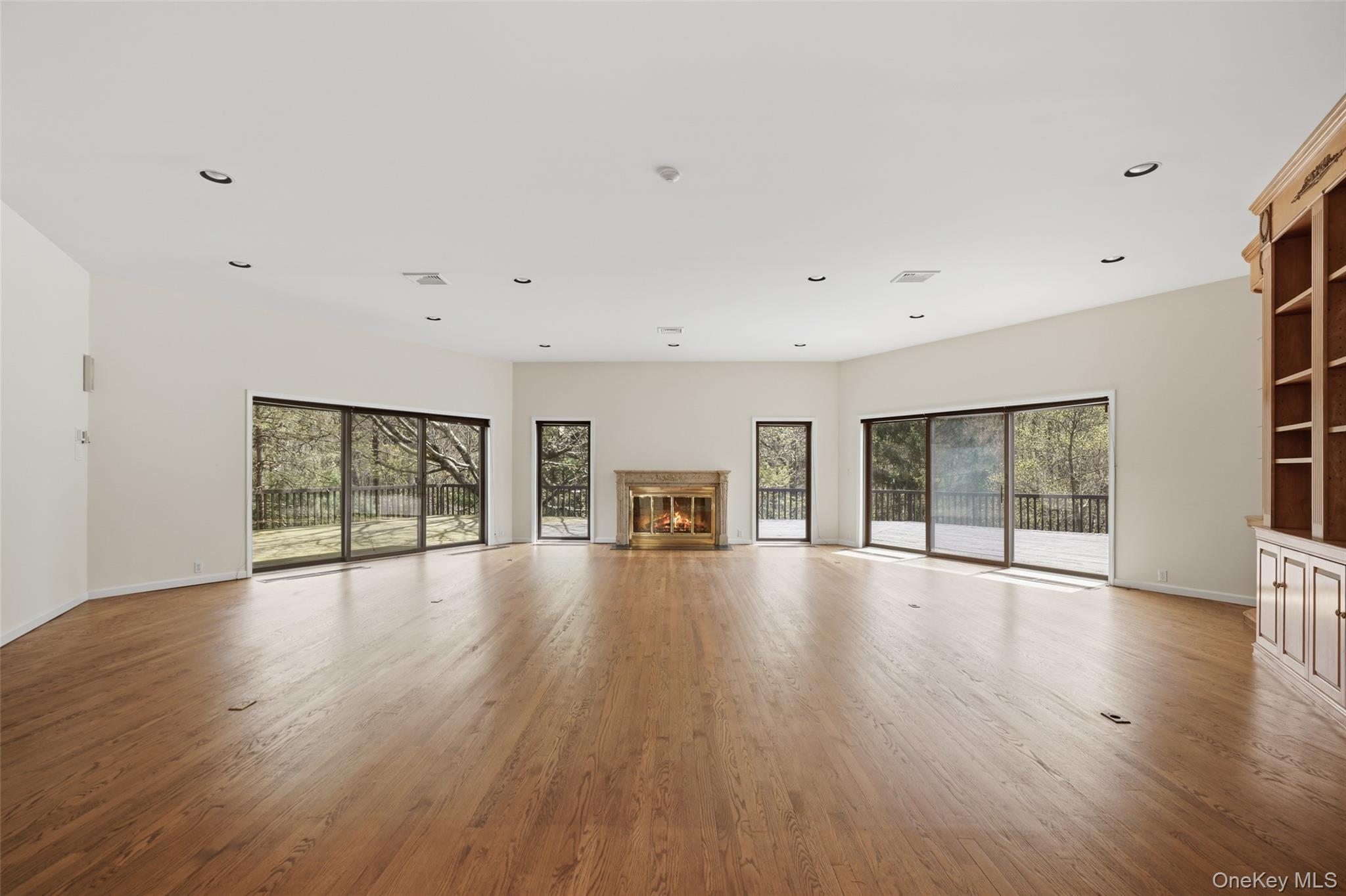 68 Old Aspetong Road Katonah, NY 10536 - Photo 7 of 13 a view of an empty room with wooden floor and a window