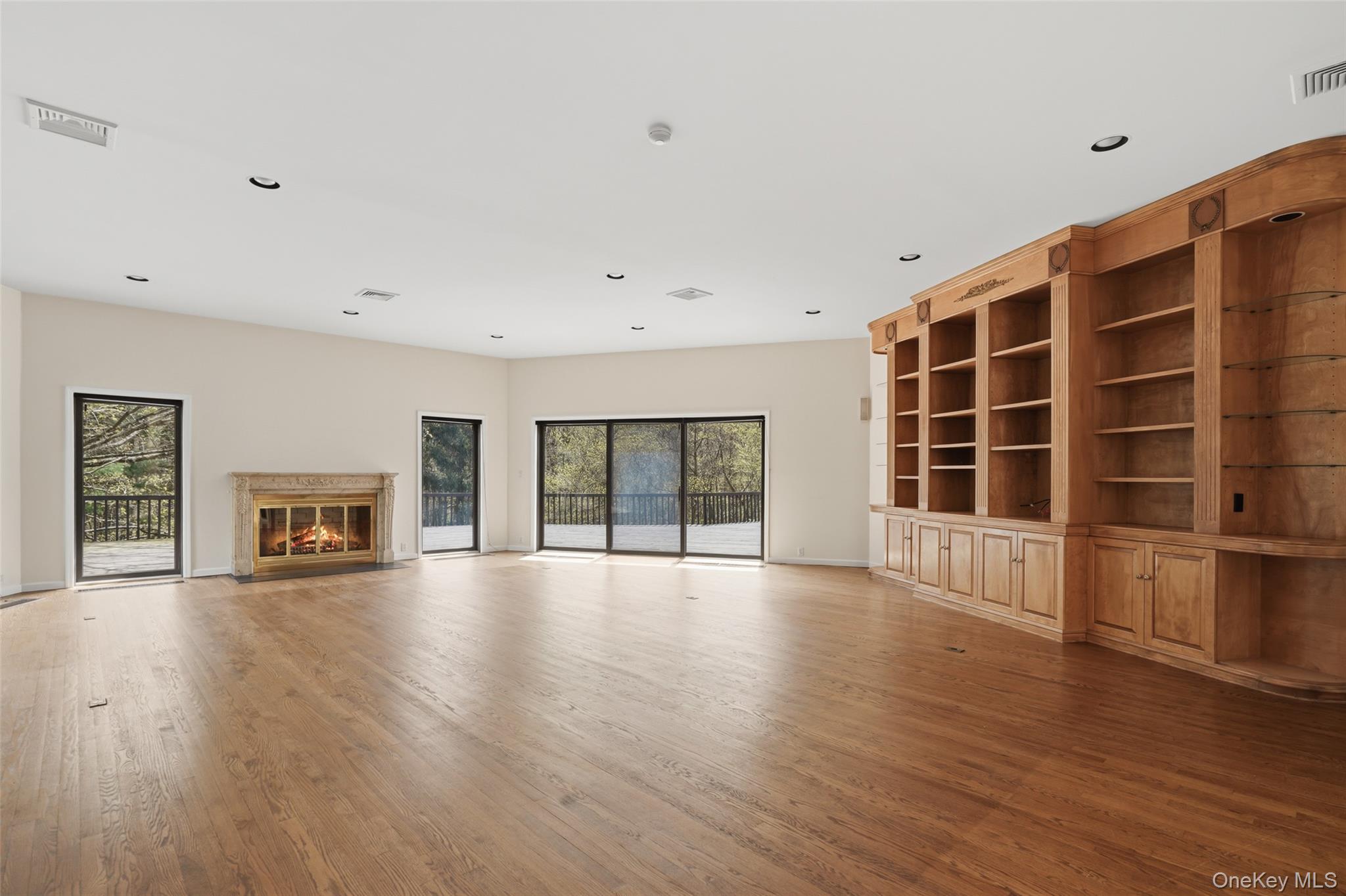 68 Old Aspetong Road Katonah, NY 10536 - Photo 8 of 13 a view of an empty room with wooden floor and a window