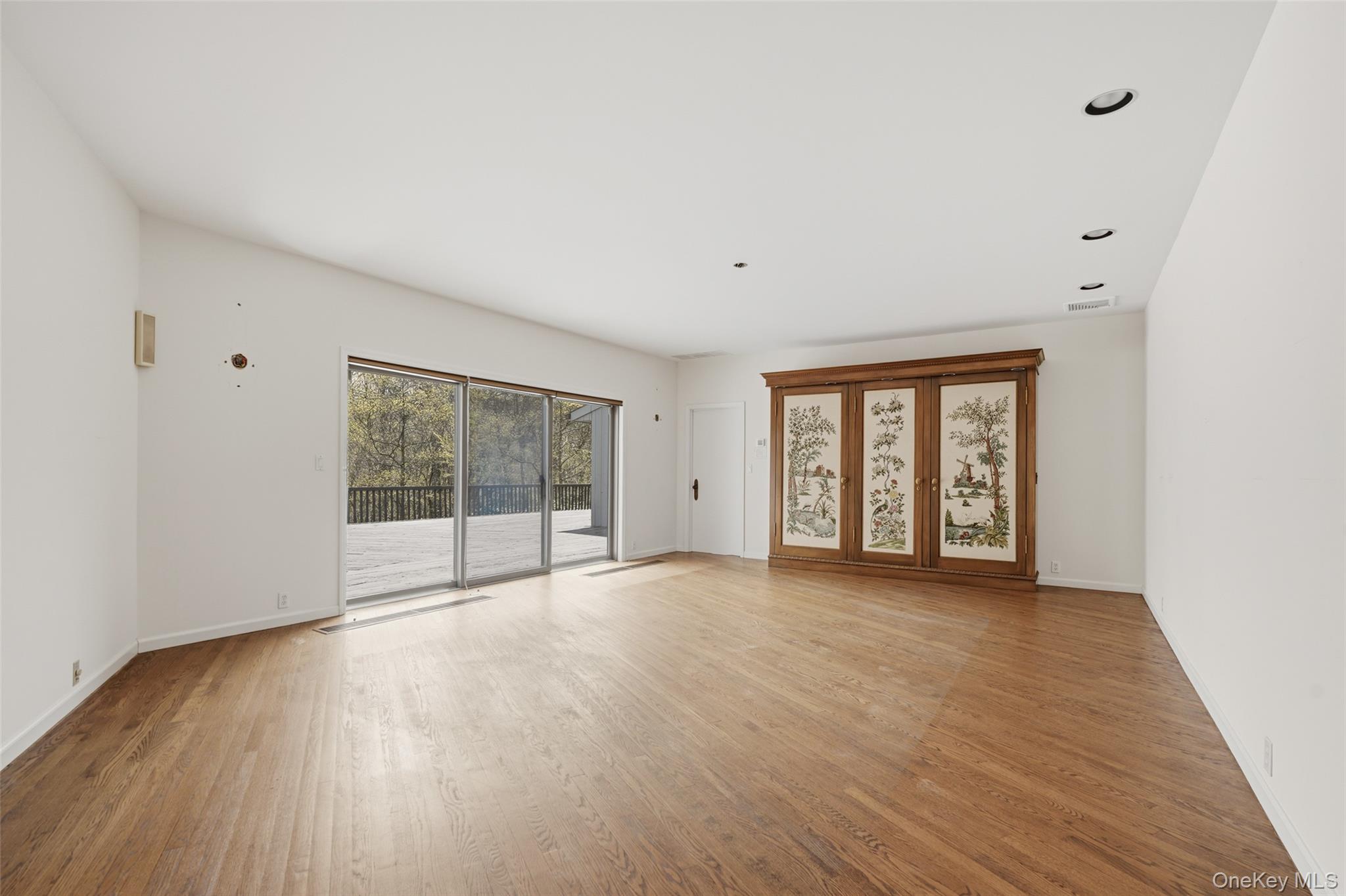 68 Old Aspetong Road Katonah, NY 10536 - Photo 9 of 13 a view of an empty room with wooden floor and a window