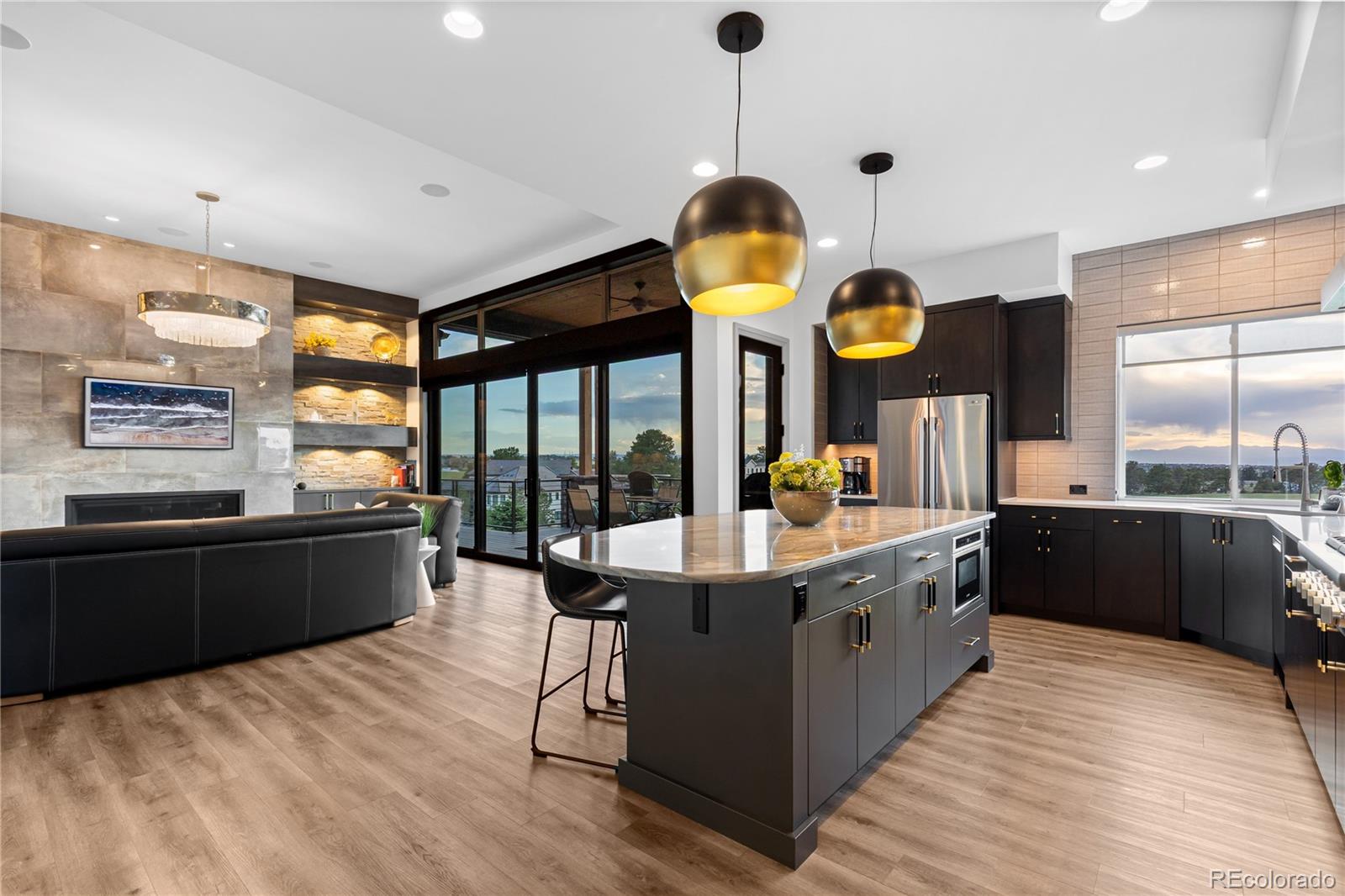 10689 Shadow Pines Road Parker, CO 80138 - Photo 15 of 50 a large kitchen with stainless steel appliances kitchen island granite countertop a large counter top and a stove