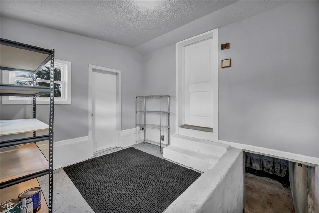 5639 Trumbull Road Geneva, OH 44041 - Photo 17 of 35 Miscellaneous room featuring a textured ceiling and concrete floors