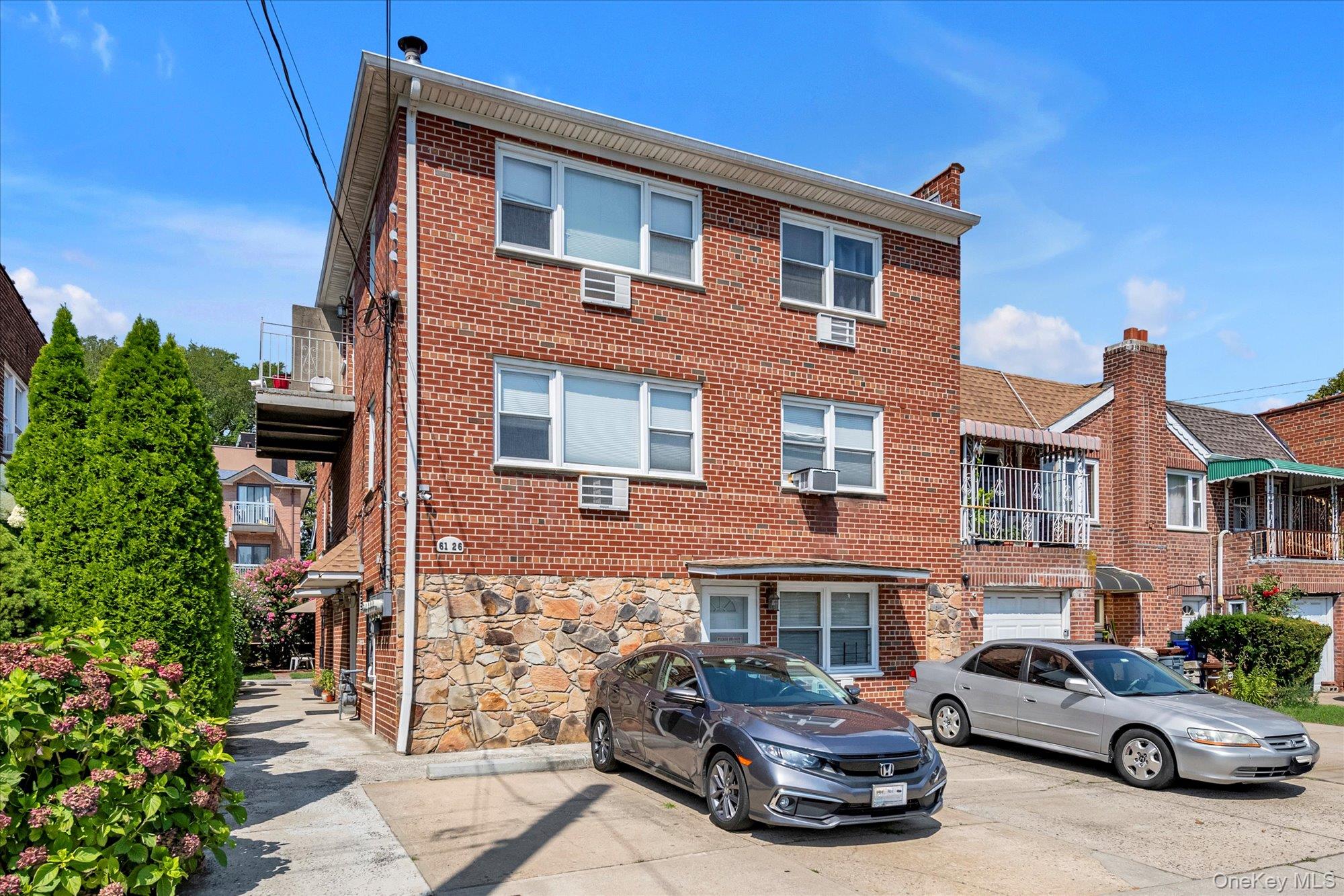a car parked in front of a brick house