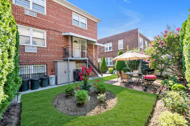 a view of a house with a yard and sitting area
