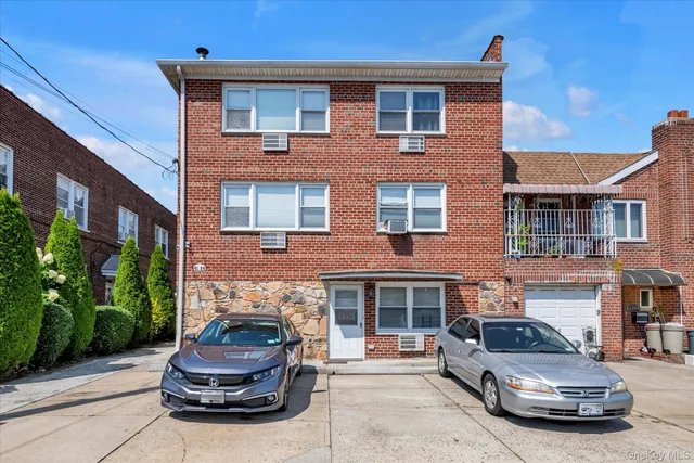 a car parked in front of a brick house