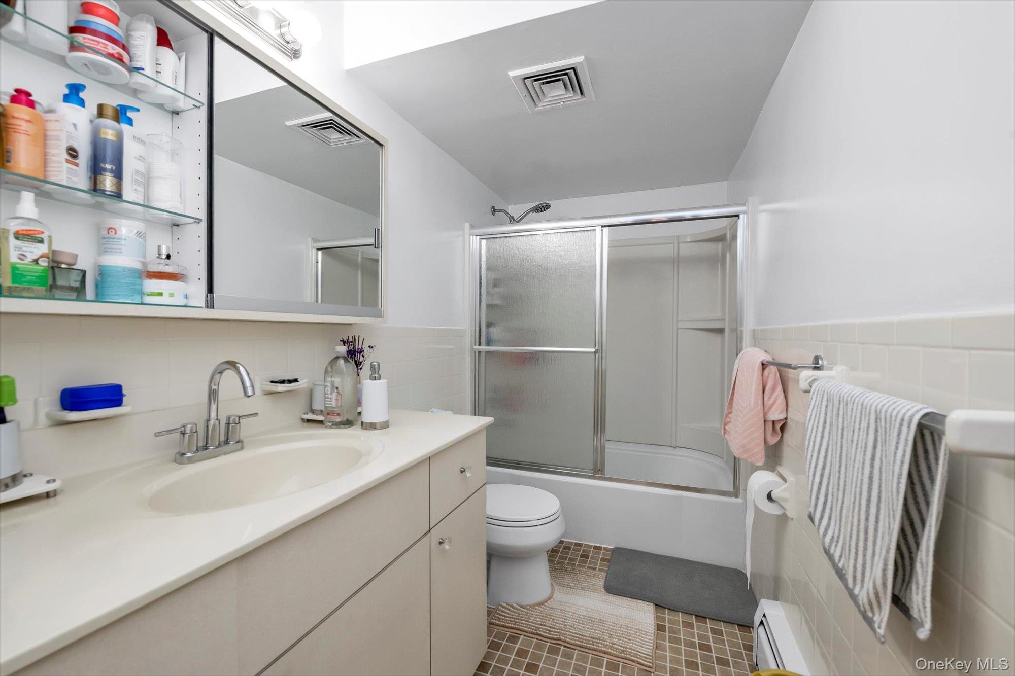 61-26 164th Street Queens, NY 11365 - Photo 16 of 17 a bathroom with a sink toilet and shower